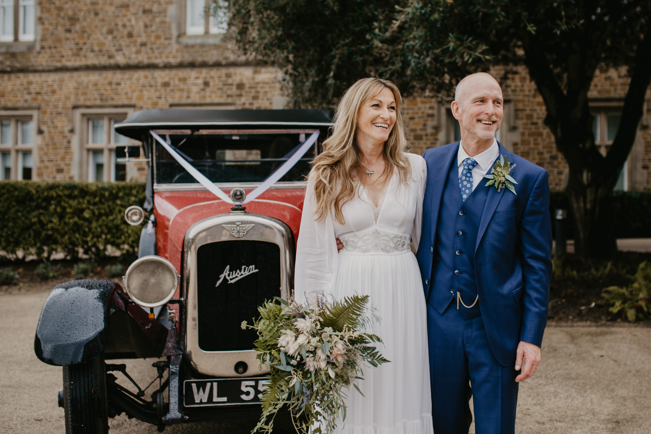 Married couple in front of vintage car